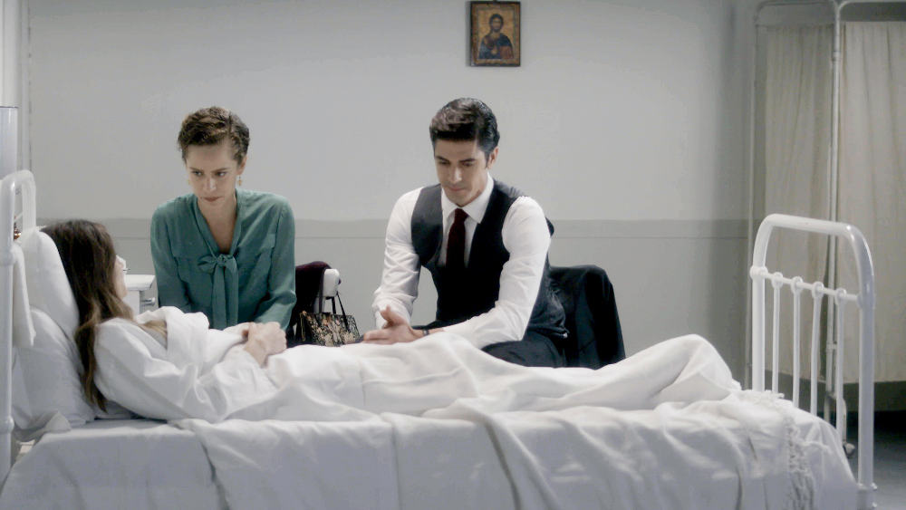 Eleni in the hospital bed with Lambros and Asimina