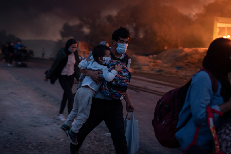 Fire in Moria A man with a child runs to escape the flames