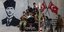 Σύριοι στρατιώτες ξεκουράζονται σε όχημα δίπλα από γκράφιτι του Κεμάλ