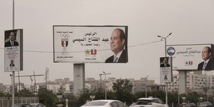 Οχήματα περνούν κάτω από μια διαφημιστική πινακίδα που υποστηρίζει τον Αιγύπτιο Πρόεδρο Abdel Fattah el-Sissi για τις προεδρικές εκλογές στο Κάιρο